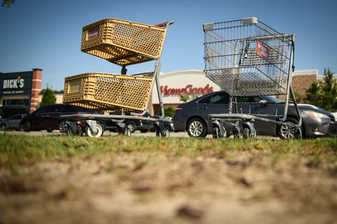 Shopping carts for Hobby Lobby and HomeGoods sit in the parking lot at Freedom Town Center.