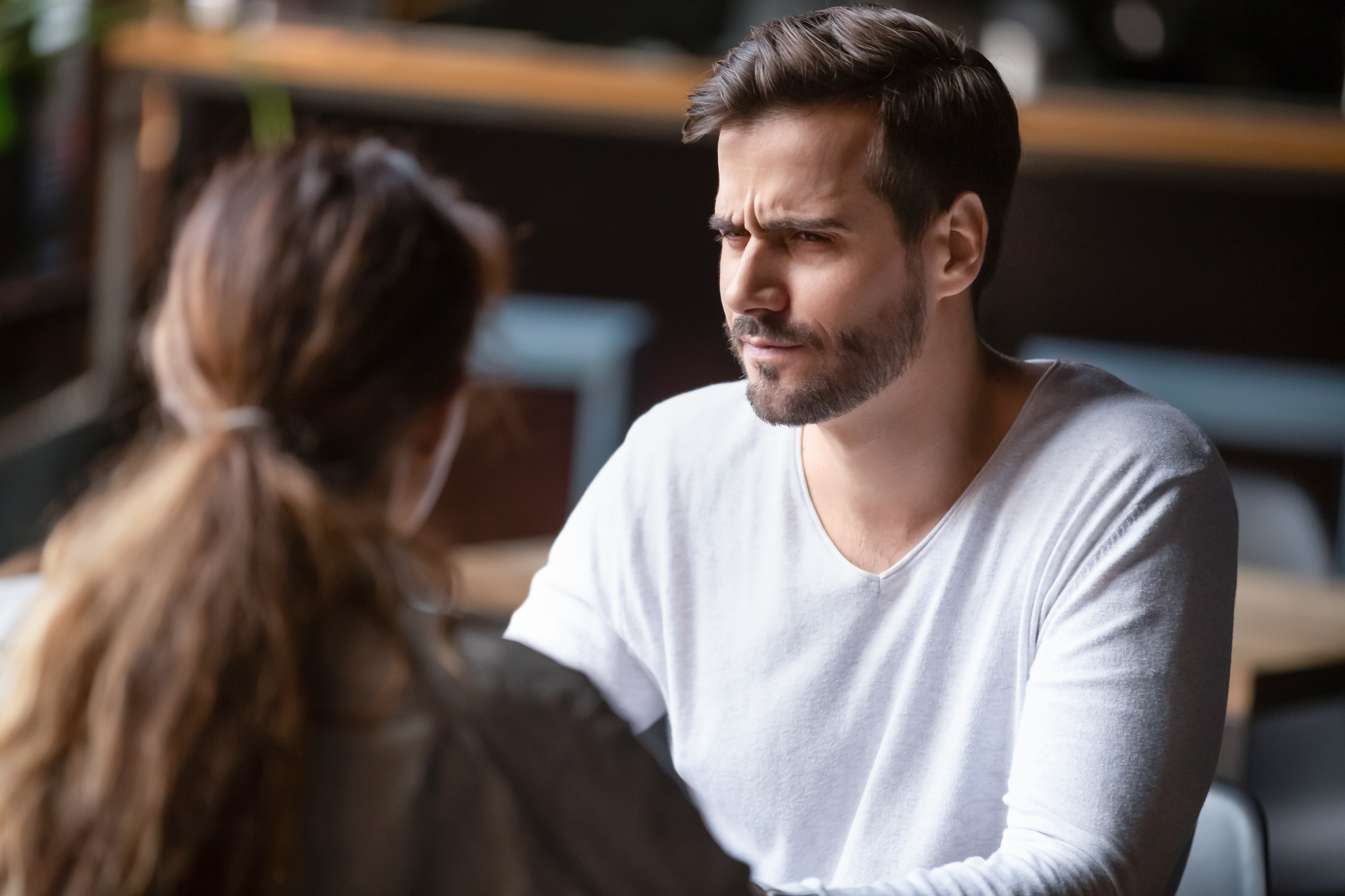 A doubting man staring at a woman | Source: Shutterstock