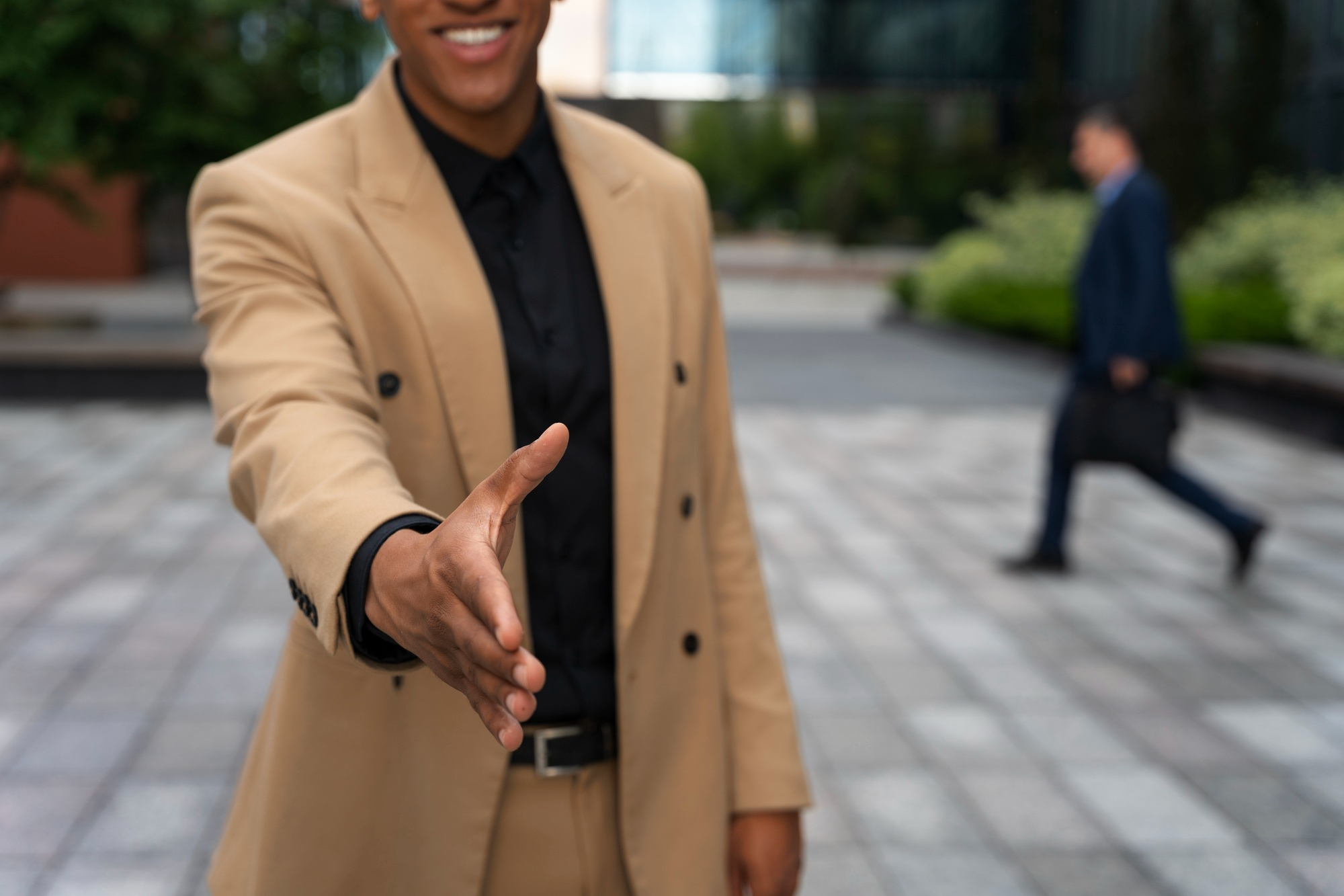 A man reaching out to shake someone's hand | Source: Freepik