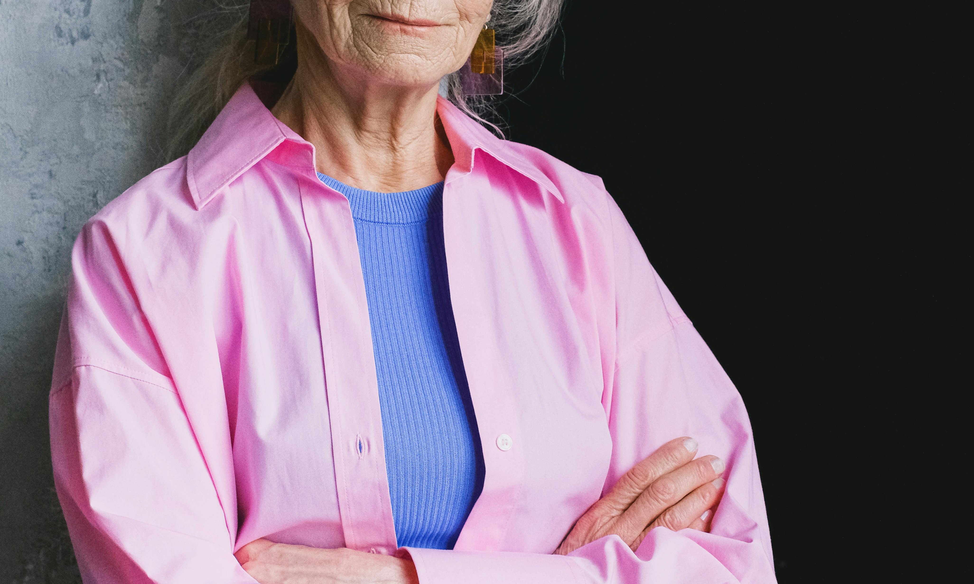 Helen standing with her arms crossed, looking defensive | Source: Pexels