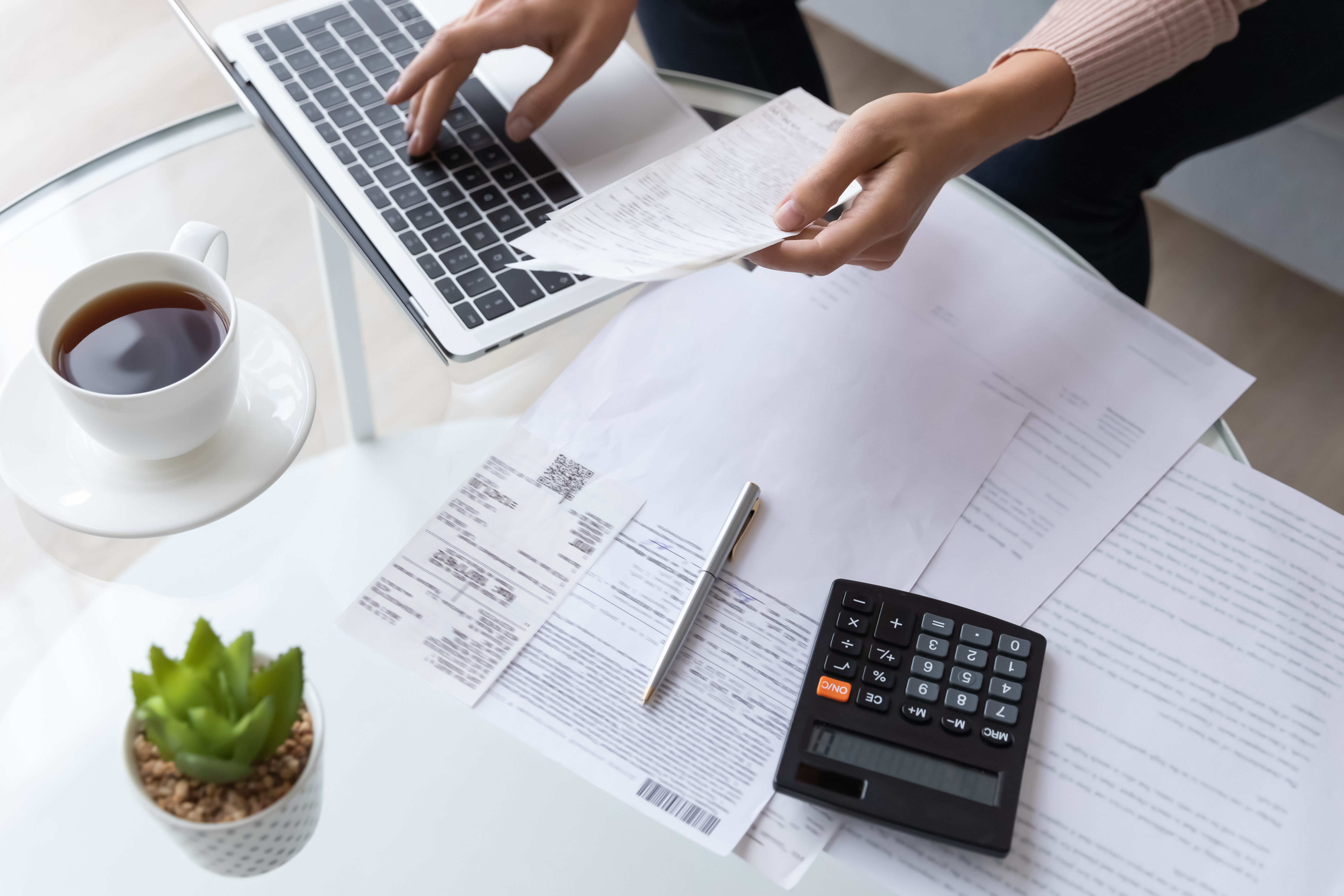 Close-up photo of a person going through financial records | Source: Shutterstock