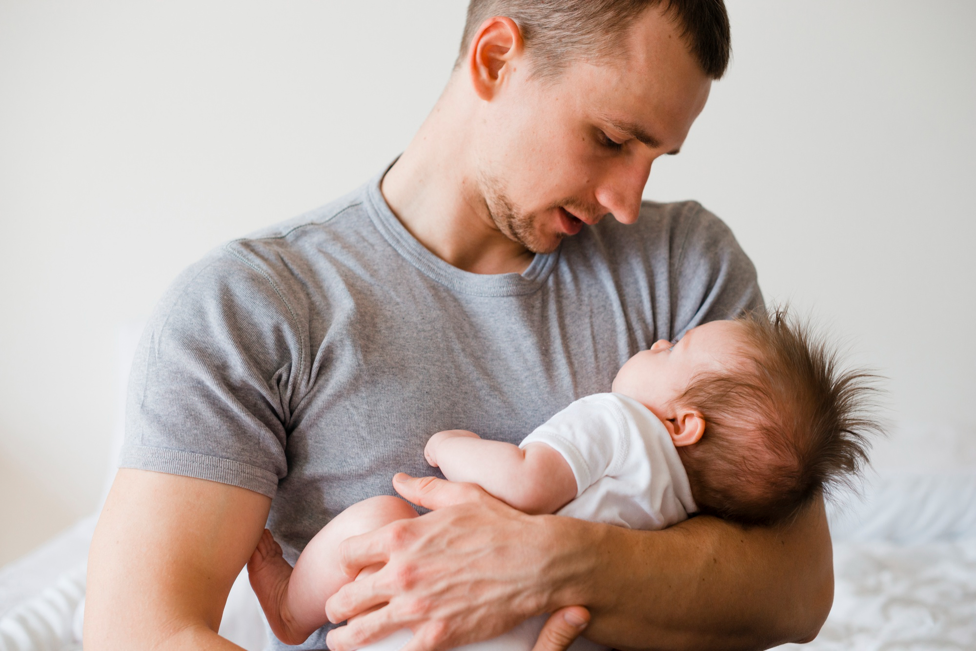 A man lovely holding his baby | Source: Freepik