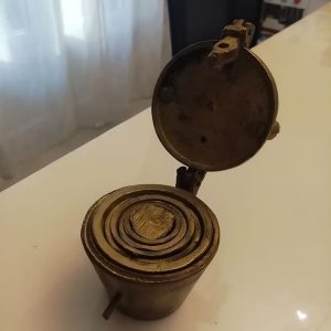 Discovered small brass cups that nest inside each other and lock shut. Any guesses on what they are Discovered small brass cups that nest inside each other and lock shut. Any guesses on what they are